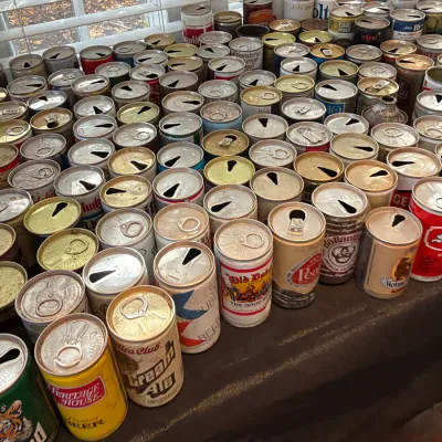 Sale Photo Thumbnail #155: Large collection of vintage pull-tab and flat-top steel beer cans, featuring various regional and national brands from the mid-20th century.