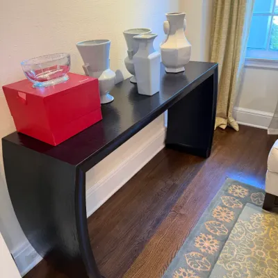 Sale Photo Thumbnail #124: Black lacquered Asian-inspired console table, topped with a selection of white ceramic vases, a red Baccarat box, and a crystal bowl.