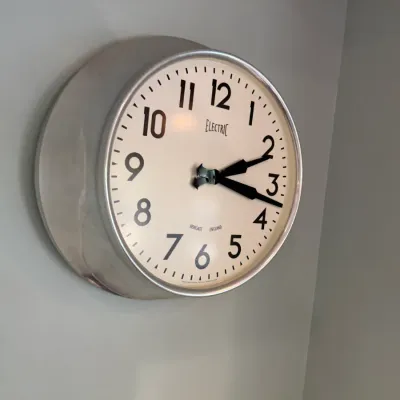 Sale Photo Thumbnail #195: Newgate Electric brand vintage-style wall clock with a brushed metal casing and bold black numerals on an off-white face.