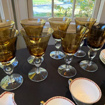Sale Photo Thumbnail #193: Set of eight vintage amber glass goblets featuring etched palm tree motifs and clear glass stems.