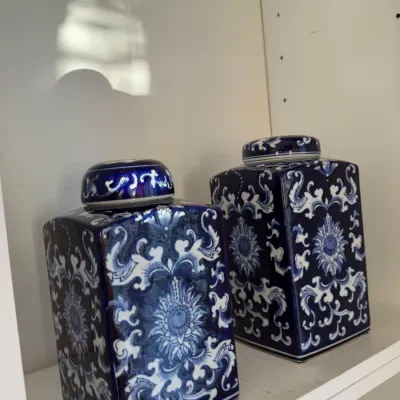 Sale Photo Thumbnail #149: Pair of square blue and white porcelain ginger jars with floral scrolling motifs and fitted lids.