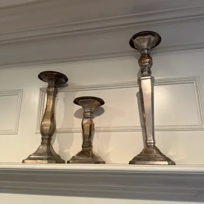 Sale Photo Thumbnail #246: Set of three silver-plated candlesticks in varying heights, showing vintage patina and tarnishing.