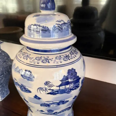 Sale Photo Thumbnail #150: Vintage Chinese blue and white ceramic ginger jar with a pointed finial lid, featuring traditional hand-painted landscape scenes.