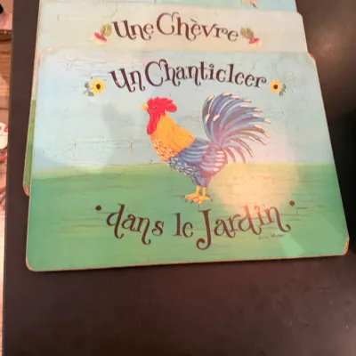 Sale Photo Thumbnail #197: Set of French country farm animal placemats with a distressed finish featuring illustrations of a rooster, goat, and pig.
