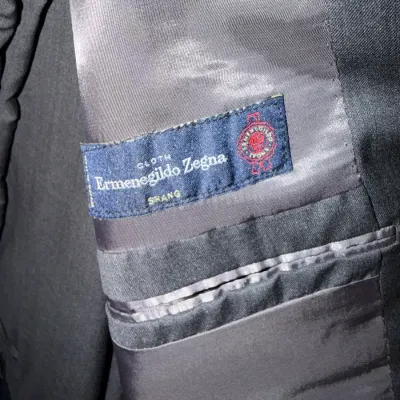 Sale Photo Thumbnail #241: Ermenegildo Zegna Shang fabric interior label on a men's dark suit jacket.