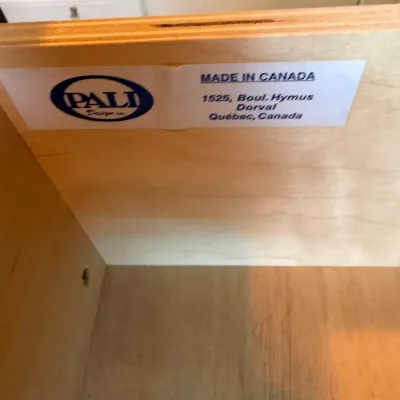 Manufacturer's label for Pali Design Inc. inside a wooden furniture drawer, reading 'Made in Canada'.