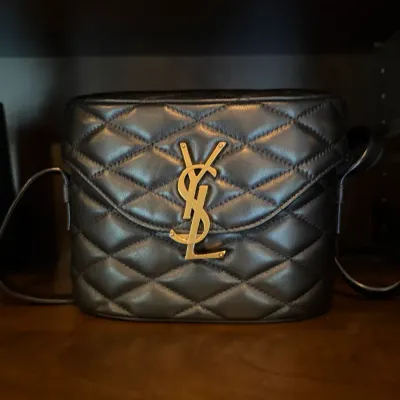 Yves Saint Laurent June quilted leather vanity shoulder bag featuring a gold-tone YSL monogram logo clasp.