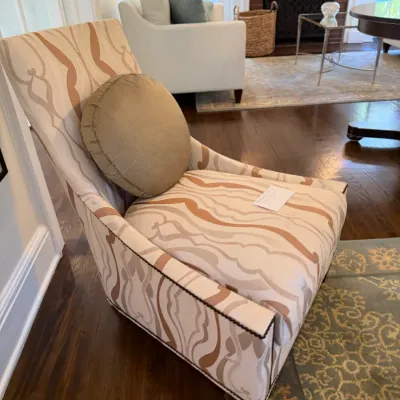Sale Photo Thumbnail #121: Contemporary high-back armchair upholstered in a beige and terracotta abstract swirl pattern with dark nailhead trim detail.