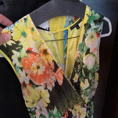 Alberto Makali size XS sleeveless dress featuring a vibrant floral pattern with a faux-wrap neckline and yellow trim.