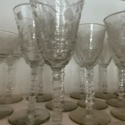Sale Photo Thumbnail #161: Collection of vintage etched glass goblets featuring delicate floral motifs and decorative knopped stems.