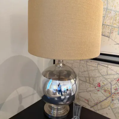 Sale Photo Thumbnail #114: Modern table lamp with a reflective mercury glass orb base and a beige textured drum shade.