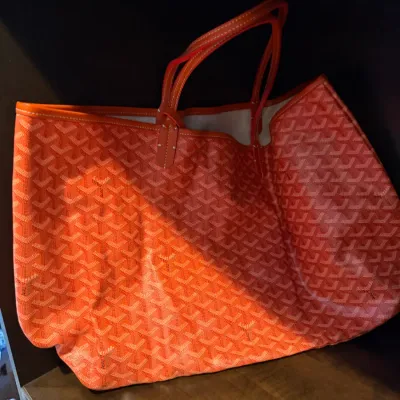 Orange Goyard Saint Louis tote bag in coated canvas with signature chevron print and leather shoulder handles.