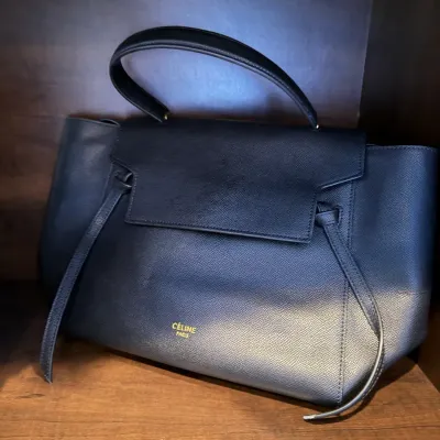 Céline black textured leather Belt Bag with gold foil logo detailing.