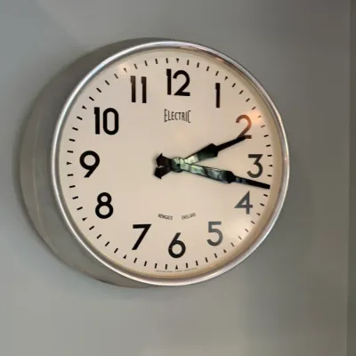 Sale Photo Thumbnail #194: Newgate England retro style 'Electric' wall clock with a brushed metal bezel and off-white face.