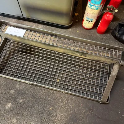 Sale Photo Thumbnail #244: Enclume wall-mounted wrought iron pot rack with a top shelf grid and lower hanging grid, showing light surface wear.