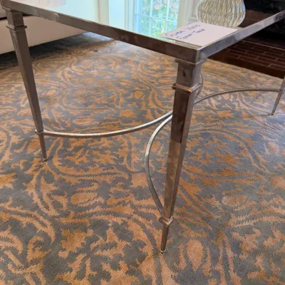 Sale Photo Thumbnail #236: Global Views contemporary silver-toned metal coffee table with a mirrored top and curved X-stretchers.