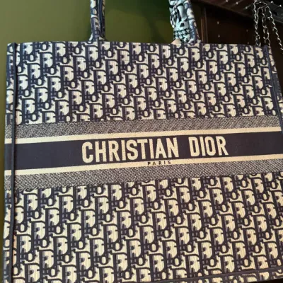 Christian Dior Book Tote in navy blue Dior Oblique embroidered canvas with structured dual top handles.