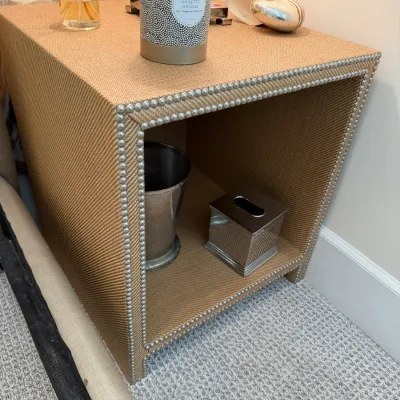 Sale Photo Thumbnail #267: Contemporary woven raffia nightstand featuring nailhead trim detailing and an open lower cubby.
