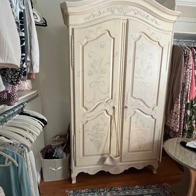 Sale Photo Thumbnail #9: French Provincial style painted armoire with hand-painted floral motifs and a arched bonnet top.