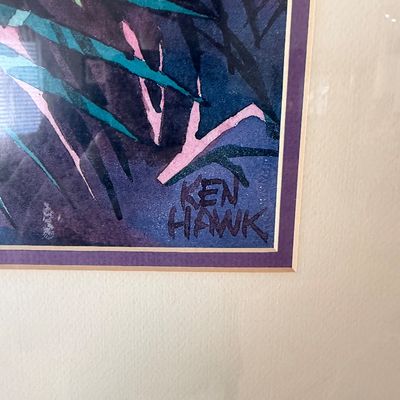 Close-up detail of a framed artwork showing the artist signature 'Ken Hawk' in the bottom corner.