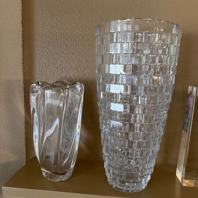 Pair of clear glass vases, including a smaller twisted swirl vase and a larger textured block-patterned vase.