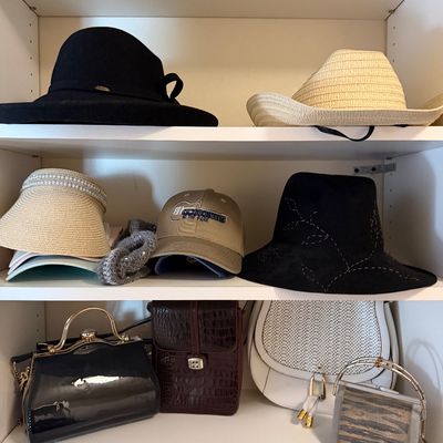 Collection of women's hats and handbags, including wide-brim felt hats, straw sun visors, baseball caps, and various vintage-style...