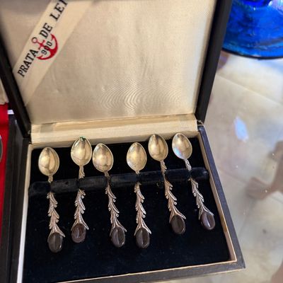 Set of six Portuguese .900 silver demitasse spoons with ornate textured handles and dark cabochon finials, presented in their original...