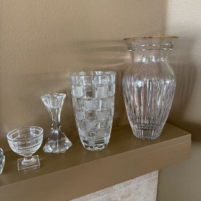 Assortment of clear crystal and glassware including a gold-rimmed ribbed vase, a frosted block pattern vase, a single candlestick holder,...