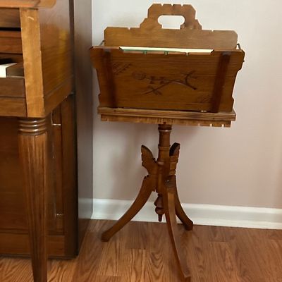 Sale Photo Thumbnail #42: Vintage carved wooden music stand featuring a leaf and rose motif on a tripod base, positioned next to a wooden organ or piano.