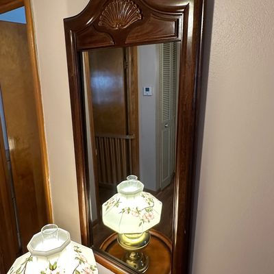 Sale Photo Thumbnail #92: Traditional dark wood wall mirror featuring a carved shell crest detail on the crown.