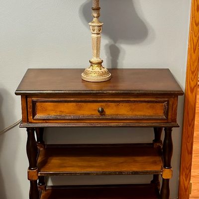 Sale Photo Thumbnail #90: Traditional wooden nightstand featuring a top drawer, turned legs, and two lower open shelves
