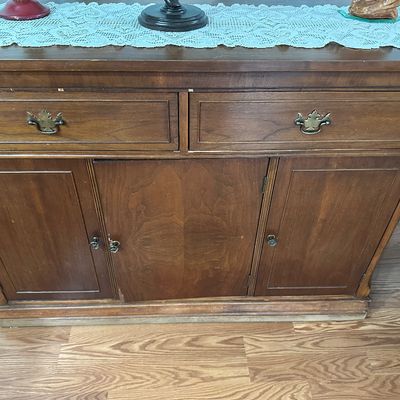 Sale Photo Thumbnail #110: Vintage dark wood buffet server featuring two upper drawers with brass hardware over three lower cabinet doors.