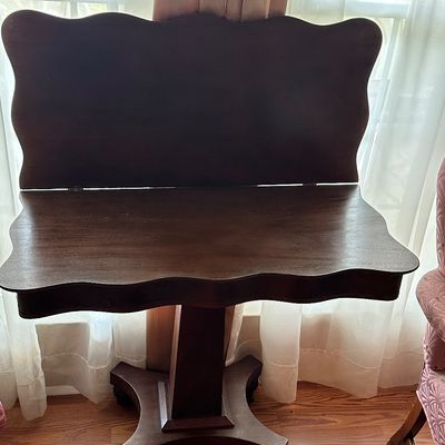 Sale Photo Thumbnail #48: Antique mahogany tilt-top tea table featuring a scalloped edge and a pedestal base on casters.