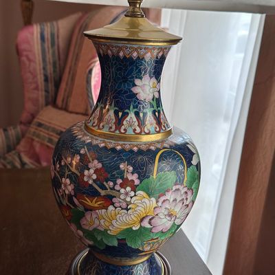 Sale Photo Thumbnail #53: Vintage Chinese cloisonné enamel table lamp featuring intricate floral motifs over a dark blue ground, mounted on a carved wooden base.