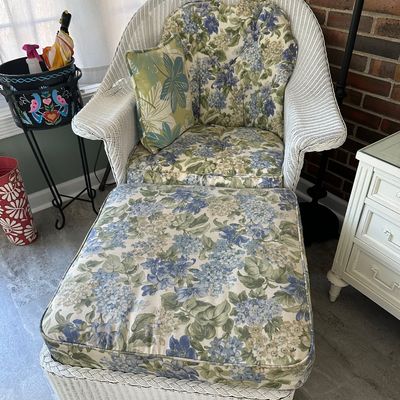 Sale Photo Thumbnail #9: White wicker armchair and matching ottoman with blue floral pattern cushions and a throw pillow.