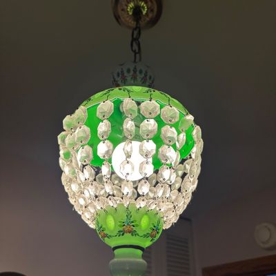 Sale Photo Thumbnail #15: Vintage Bohemian-style green cased glass chandelier featuring hand-painted floral motifs and cascading faceted glass prisms.