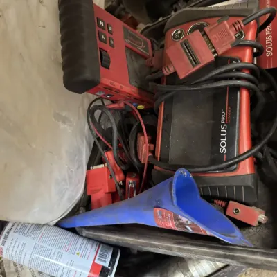 Sale Photo Thumbnail #62: Snap-on Solus Pro diagnostic scanner with accompanying diagnostic tools, cables, and a blue funnel stored in a hard case.