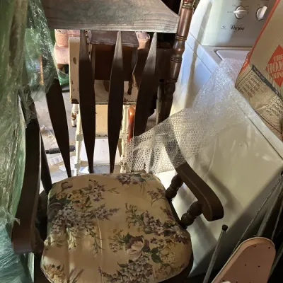 Sale Photo Thumbnail #102: Vintage dark wood armchair with a floral upholstered seat cushion and turned spindle posts.