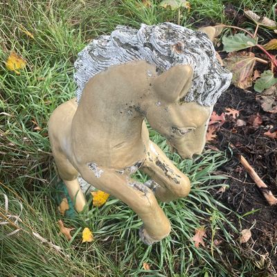 Sale Photo Thumbnail #166: Vintage painted concrete lawn ornament depicting a rearing horse, showing significant weathering and paint peeling.
