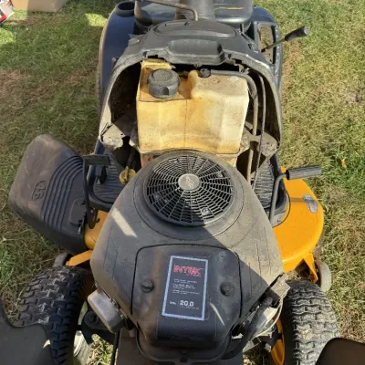 Sale Photo Thumbnail #123: Poulan Pro riding lawn mower with the hood open, revealing a Briggs & Stratton Intek 20.0 HP V-twin engine and translucent fuel tank.