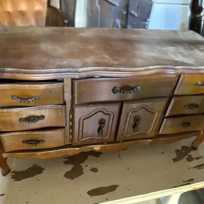 Sale Photo Thumbnail #108: Vintage French Provincial style wooden jewelry chest shaped like a mini dresser, featuring multiple small drawers and cabinet doors.