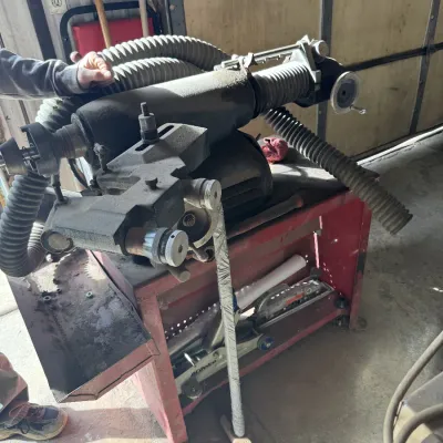 Sale Photo Thumbnail #94: Heavy-duty brake lathe mounted on a red metal utility cart, equipped with flexible dust collection hoses and showing signs of shop use.