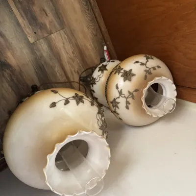 Sale Photo Thumbnail #53: Pair of vintage Gone with the Wind style milk glass hurricane lamps featuring raised floral metal filigree accents and clear glass chimneys.