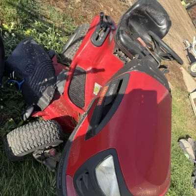 Sale Photo Thumbnail #141: Craftsman LT3000 red riding lawn mower featuring a 42-inch deck, showing typical wear and tearing on the vinyl seat.