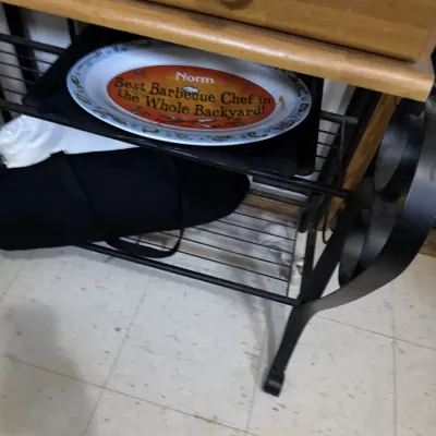 Sale Photo Thumbnail #19: Novelty barbecue platter reading "Norm Best Barbecue Chef in the Whole Backyard!", stored on a wrought iron and wood kitchen baker's rack.