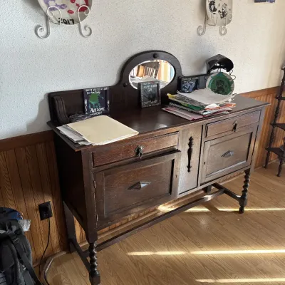Sale Photo Thumbnail #46: Antique dark oak buffet cabinet featuring a small oval mirror, barley twist legs, and raised diamond panel details.