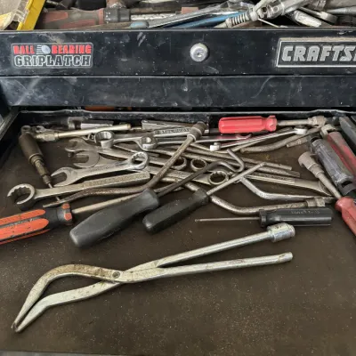 Sale Photo Thumbnail #82: Black Craftsman Ball Bearing Griplatch tool chest filled with various hand tools, including wrenches, screwdrivers, and specialty automotive tools.