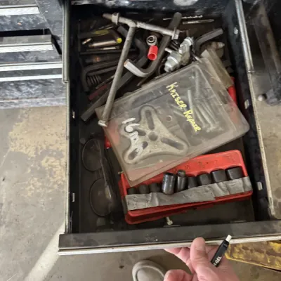 Sale Photo Thumbnail #85: Open toolbox drawer filled with various hand tools, specialty automotive repair tools, Allen keys, and a socket set.