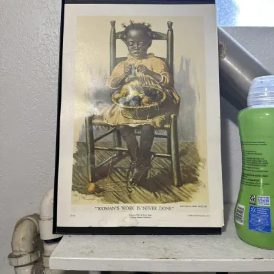 Sale Photo Thumbnail #13: Framed art print titled "Woman's Work is Never Done" after the original painting by Harry Roseland, featuring a young girl knitting in a wooden chair.