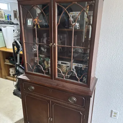 Sale Photo Thumbnail #22: Traditional mahogany china cabinet with broken-arch pediment, gothic-arched glass display doors, and lower storage cabinet.